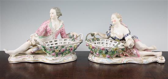 A pair of English porcelain figural sweetmeat dishes, mid 19th century, after the Meissen originals, length 29cm, restorations